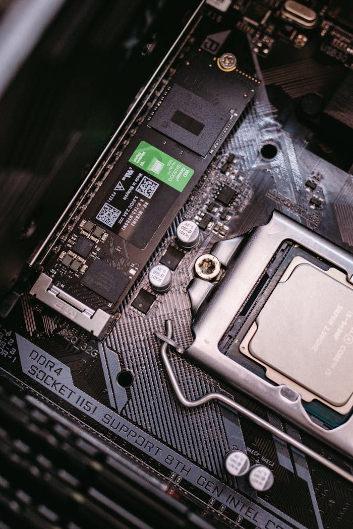 services-02 Detailed view of a computer motherboard with a CPU and an installed SSD, highlighting modern technology components.