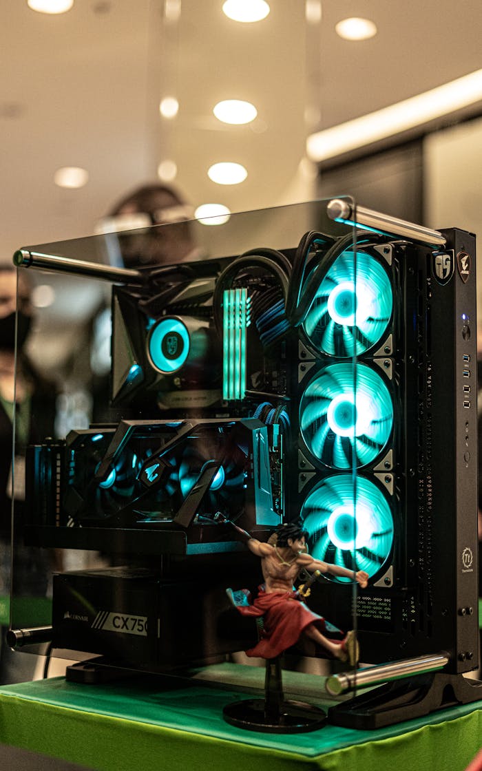hero-img-02 Vertical shot of a powerful gaming PC with illuminated RGB components on display indoors.