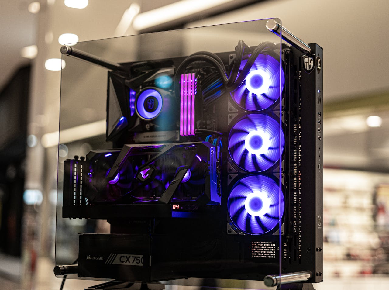 about-02 Modern gaming computer with vibrant LED fans and sleek glass design, showcasing high-performance components.